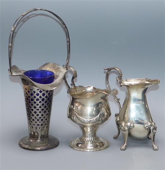 A George III silver cream jug, London, 1773, a later silver cream jug and a pierced silver posy vase with handle.